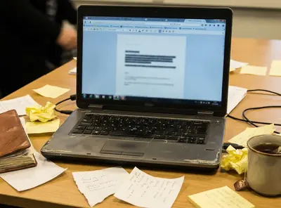 Home office writing setup with laptop displaying a half-finished draft titled The Legacy of Historic